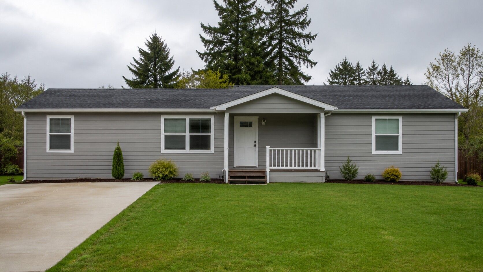 Exterior of a single-story factory-built home with a covered front porch